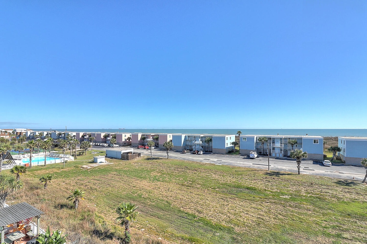Oceanfront property complex featuring modern buildings with direct beach access and sweeping coastal views.