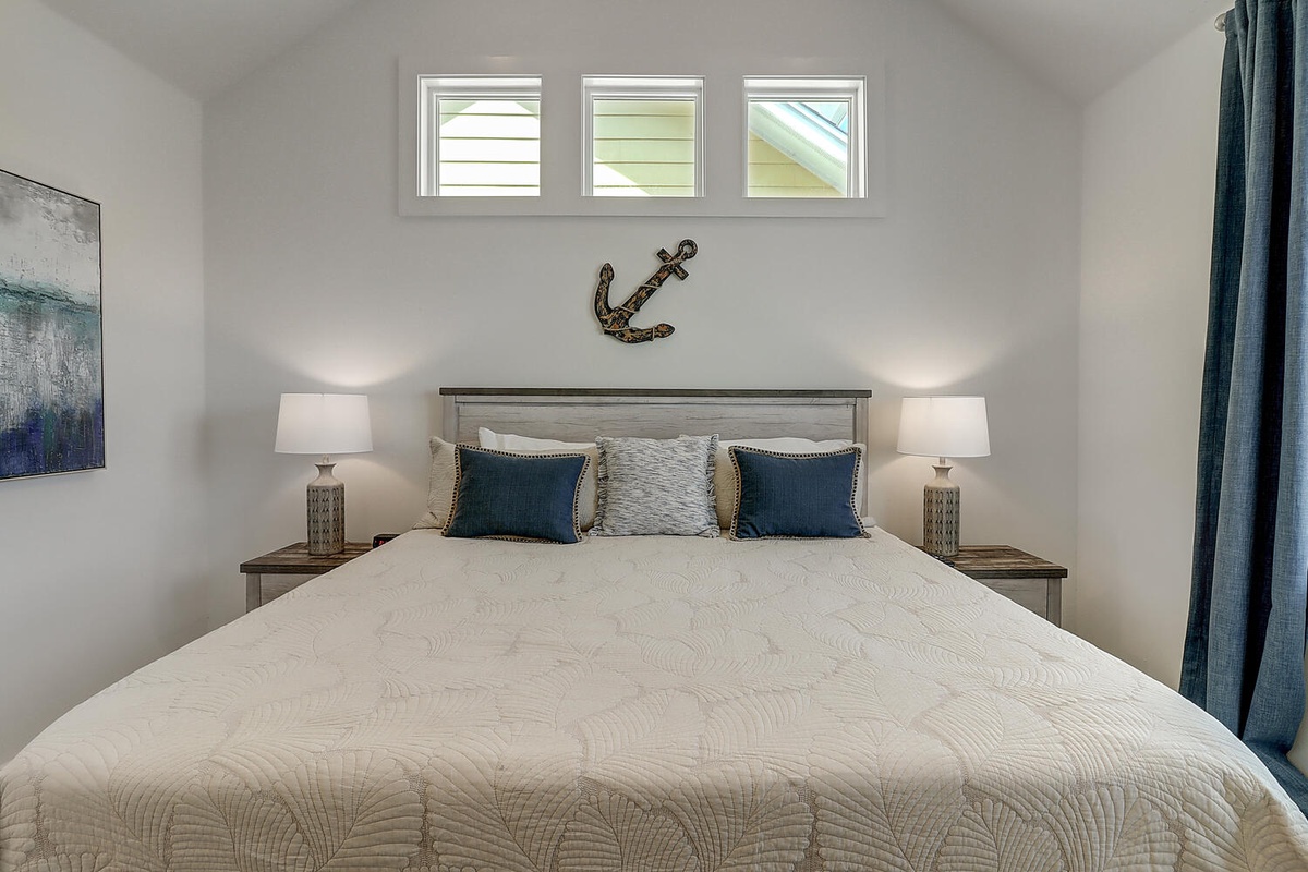 Drift into peaceful sleep in your serene bedroom, where soft nautical touches and gentle lighting create the perfect coastal retreat.