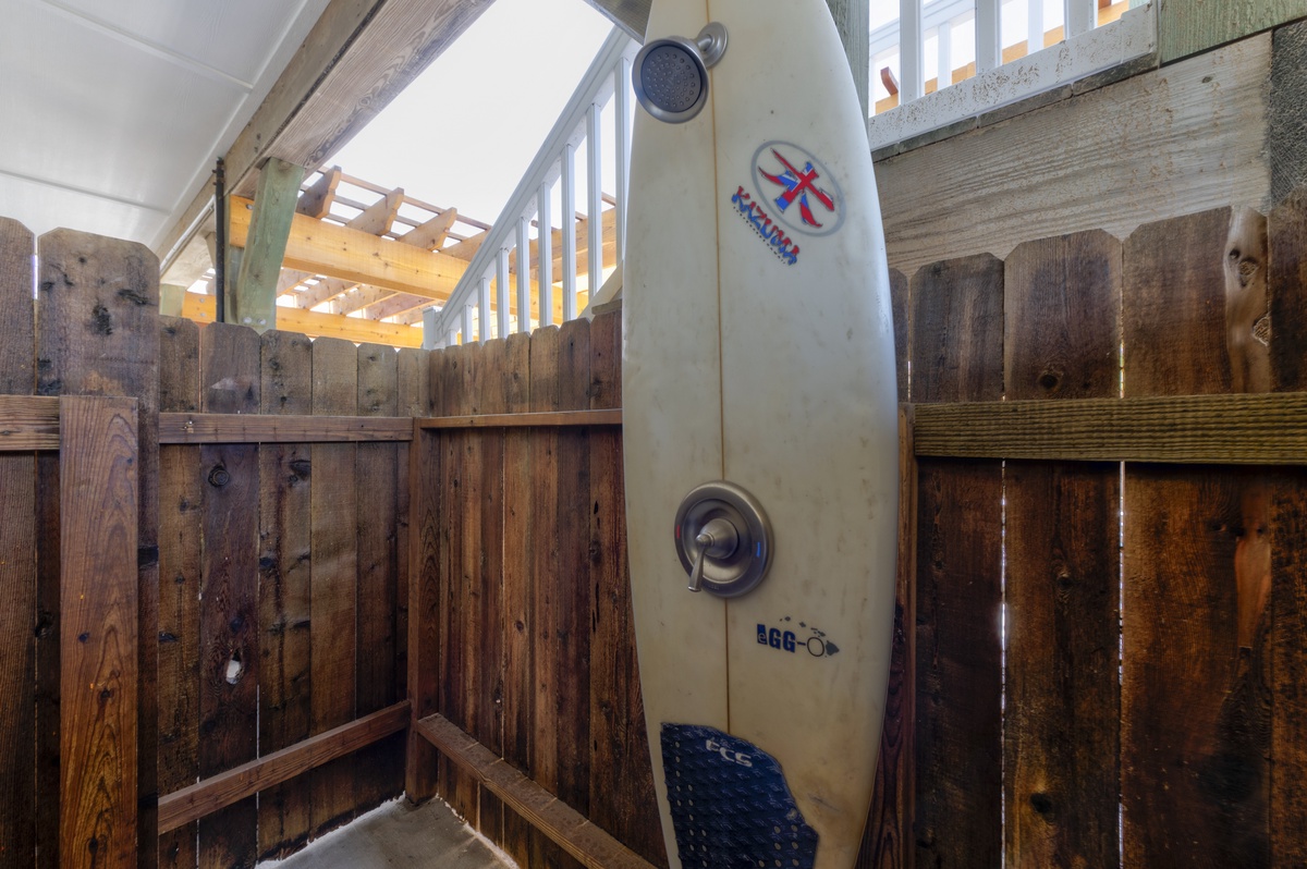 Your outdoor shower offers a refreshing escape with natural wood privacy screens and open-air design for an invigorating rinse.