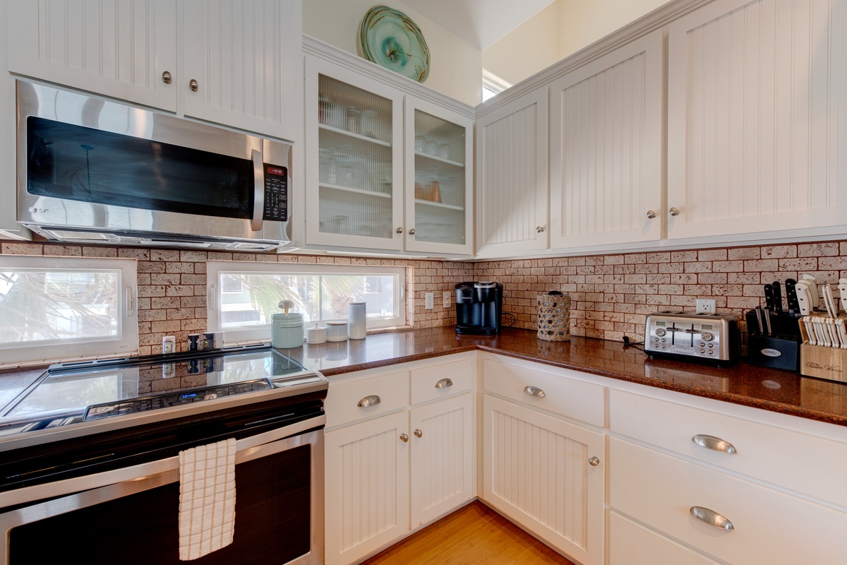 Your fully equipped kitchen features granite countertops, stainless steel appliances, and charming white cabinetry—perfect for preparing memorable meals during your stay.