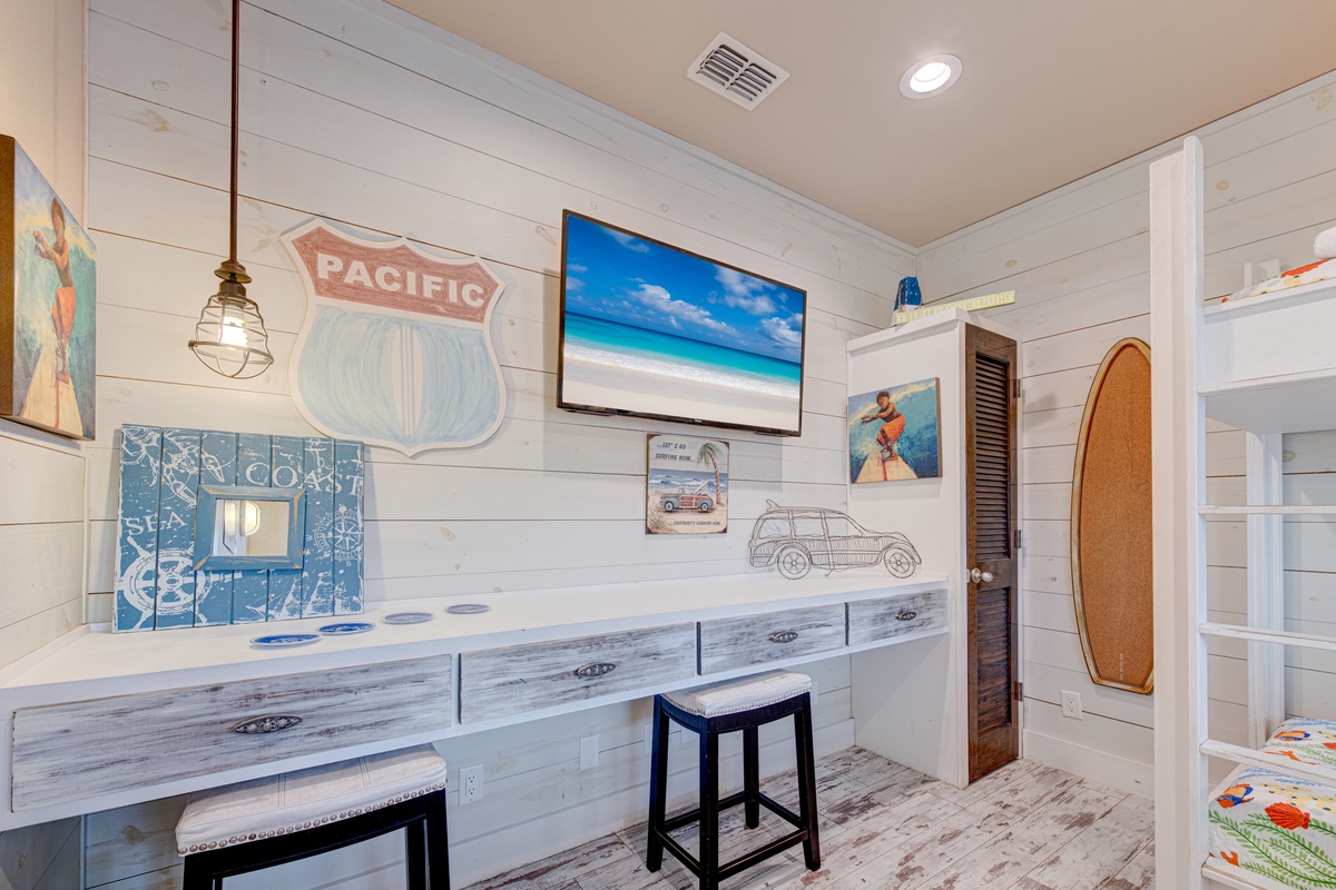 Your coastal retreat features surfboard décor and beach-themed artwork, creating the perfect space to unwind after ocean adventures.