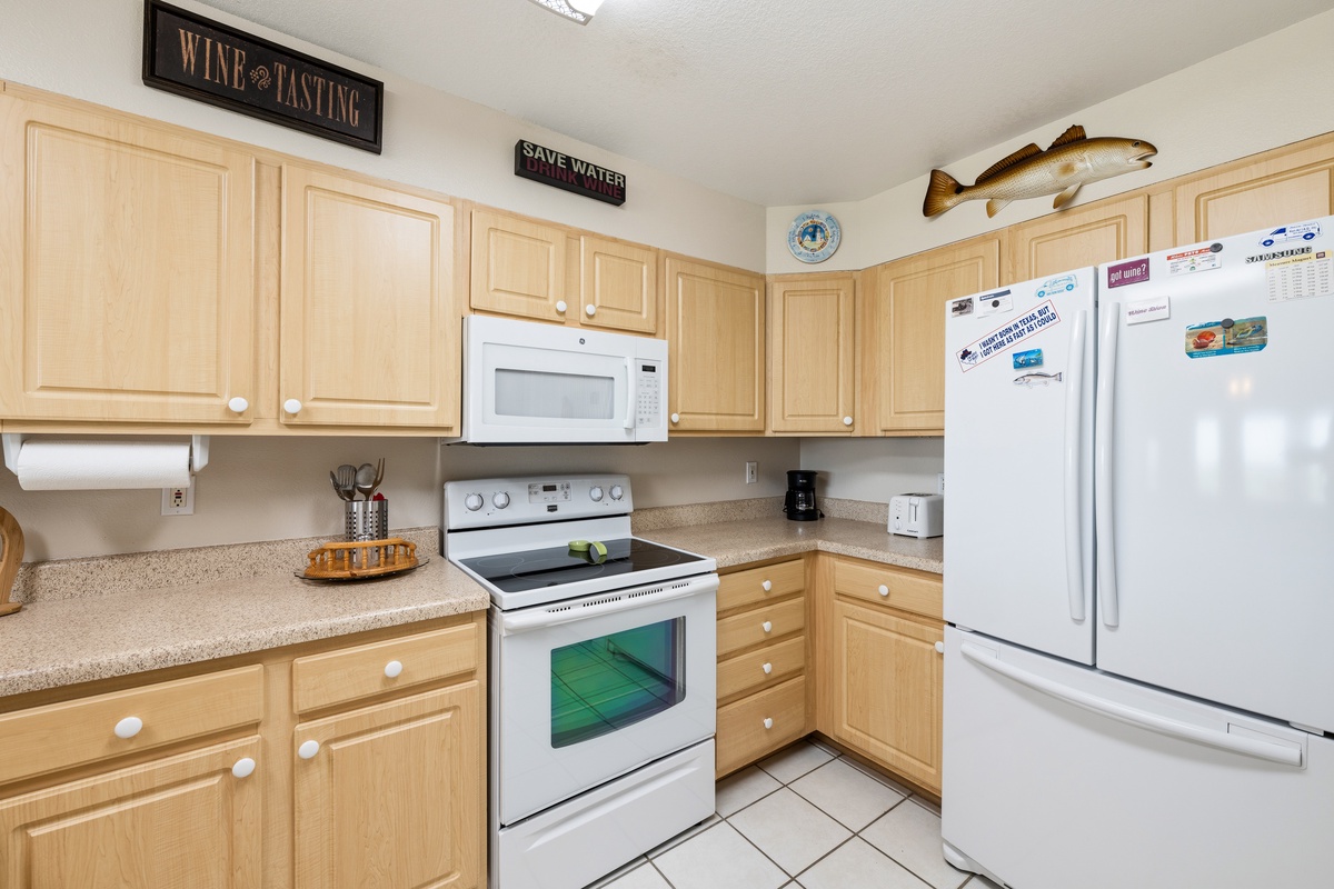 Your fully equipped kitchen has everything you need to prepare meals at your leisure. Warm wood cabinetry, ample counter space, and modern appliances make cooking feel effortless and enjoyable.