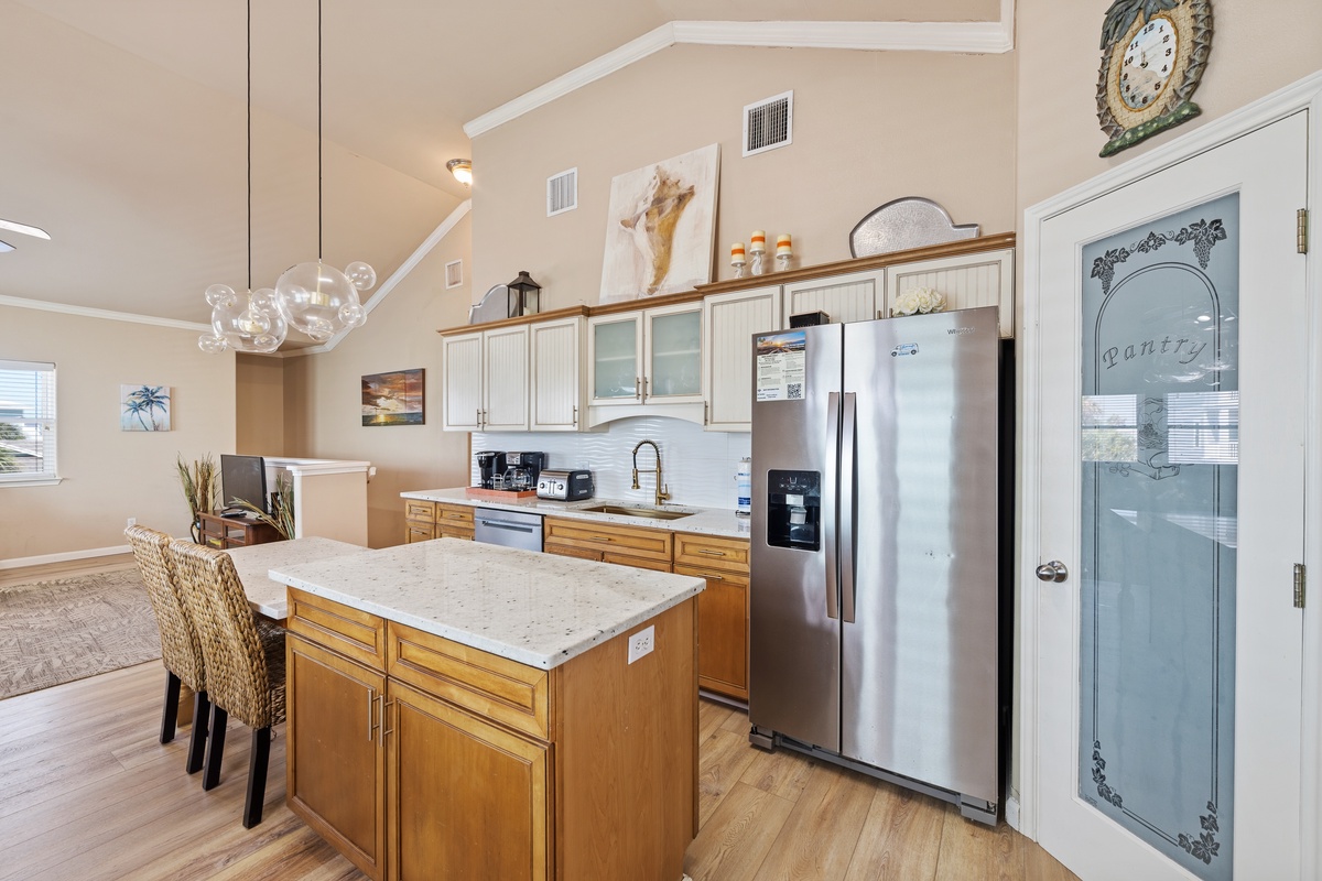 The well-appointed kitchen offers stainless steel appliances, ample prep space, and an open layout perfect for entertaining.