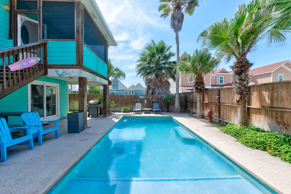 Dive into your own tropical oasis! This sparkling pool invites endless summer fun surrounded by swaying palms and colorful beach vibes.