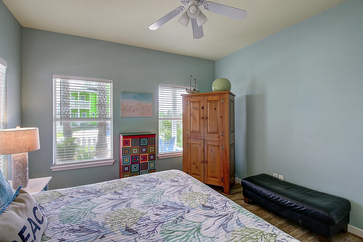 Sink into comfortable bedding while gentle breezes from your ceiling fan keep you cool in this peaceful retreat.