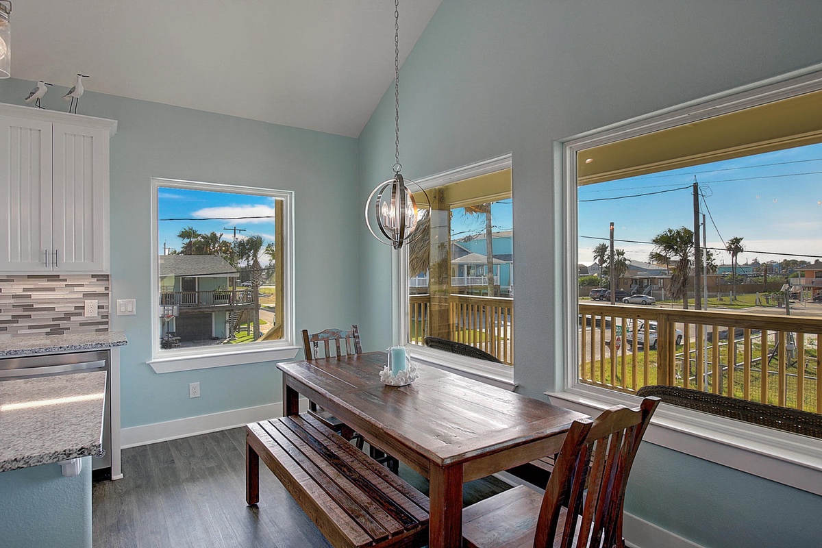 Gather around your dining table with ocean breezes flowing through large windows, creating the perfect spot for memorable meals together.