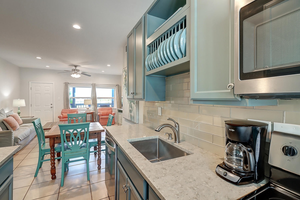 Your fully equipped kitchen features modern appliances and connects seamlessly to the bright living space, perfect for cooking meals together.