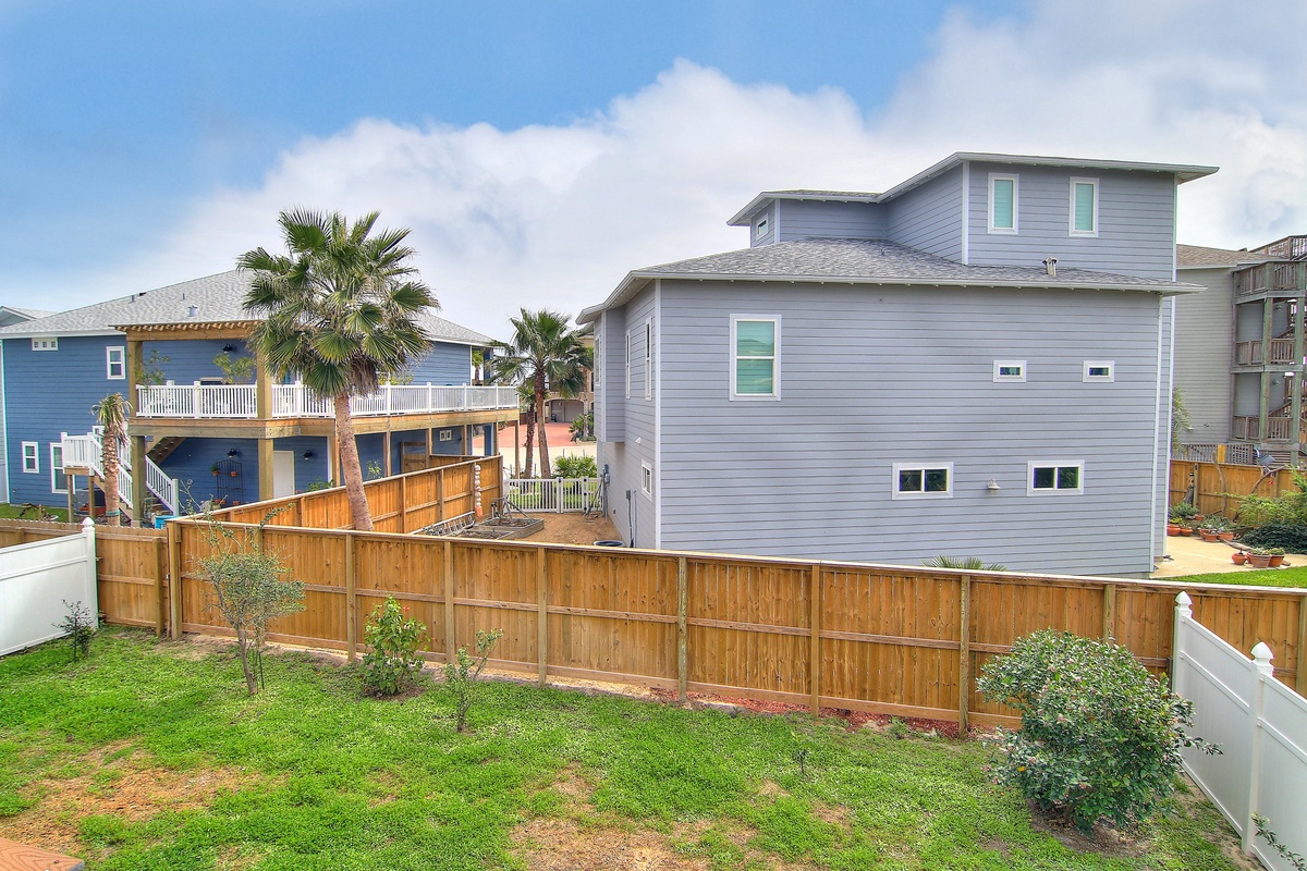 Modern coastal home nestled among palm trees in a charming beach neighborhood, offering a perfect retreat destination.