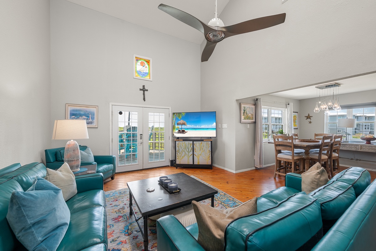 Sink into plush teal leather seating and unwind in your bright, open-concept living space with soaring ceilings and French doors opening to your private outdoor area.