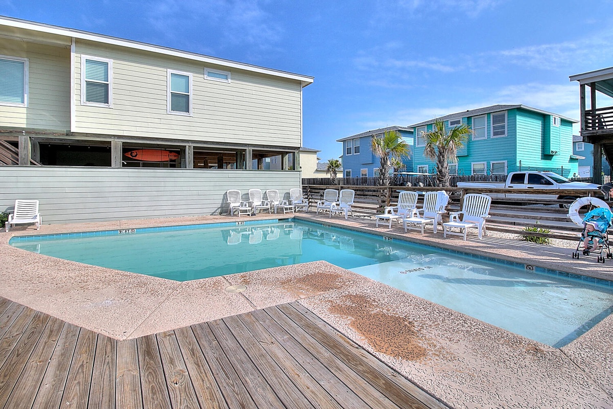 Dive into your private oasis with this sparkling pool surrounded by comfortable loungers, perfect for soaking up the coastal sun.
