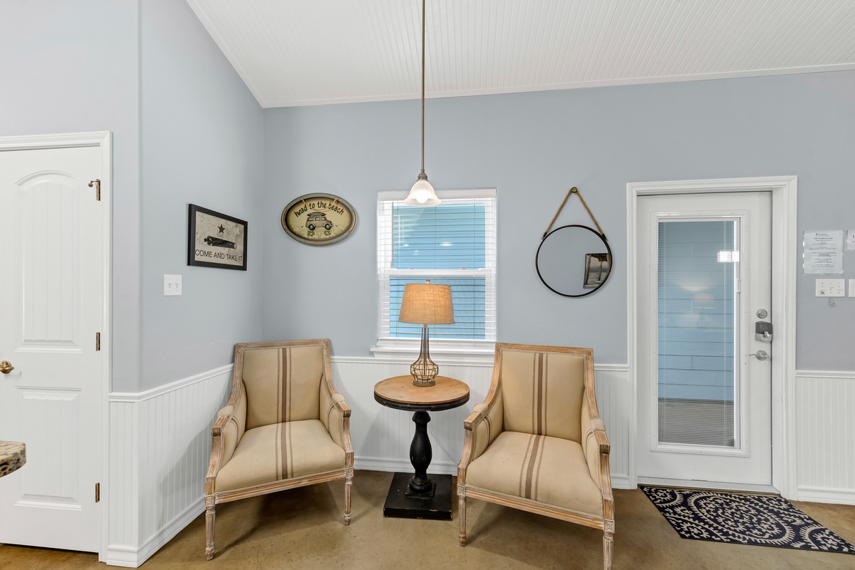 Settle into your charming reading nook with vintage-inspired chairs and warm lighting, perfect for quiet mornings with coffee.