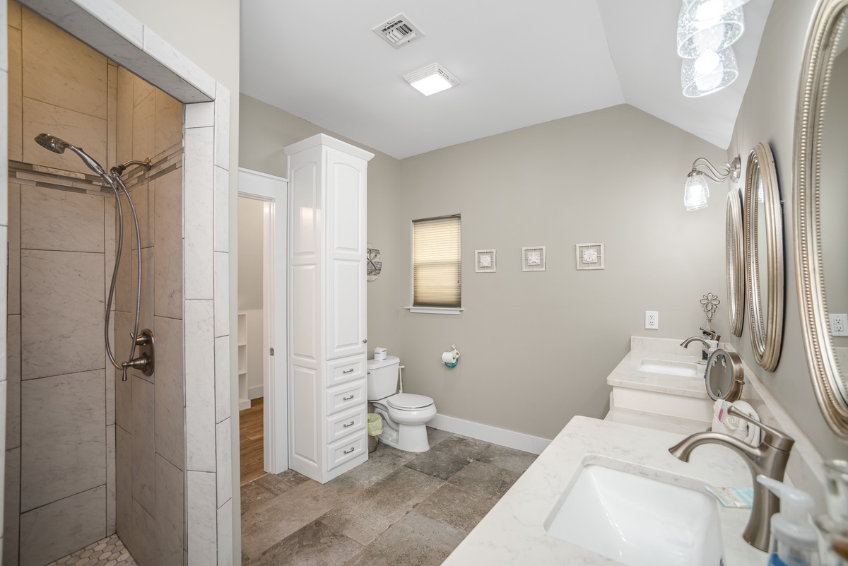 Step into your spacious en-suite bathroom with elegant dual vanities, luxurious walk-in shower, and plenty of storage for your getaway essentials.