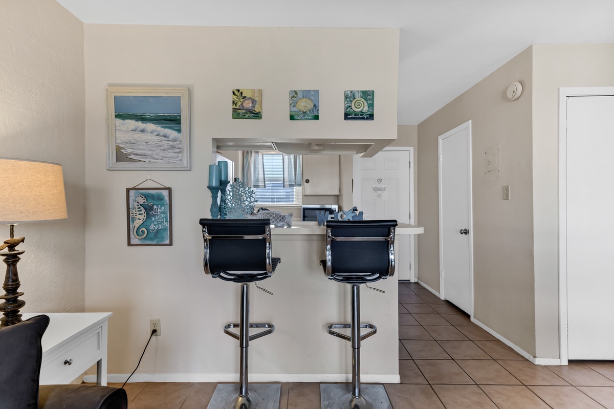 Your open kitchen features a convenient breakfast bar with stylish stools, perfect for morning coffee or casual dining.