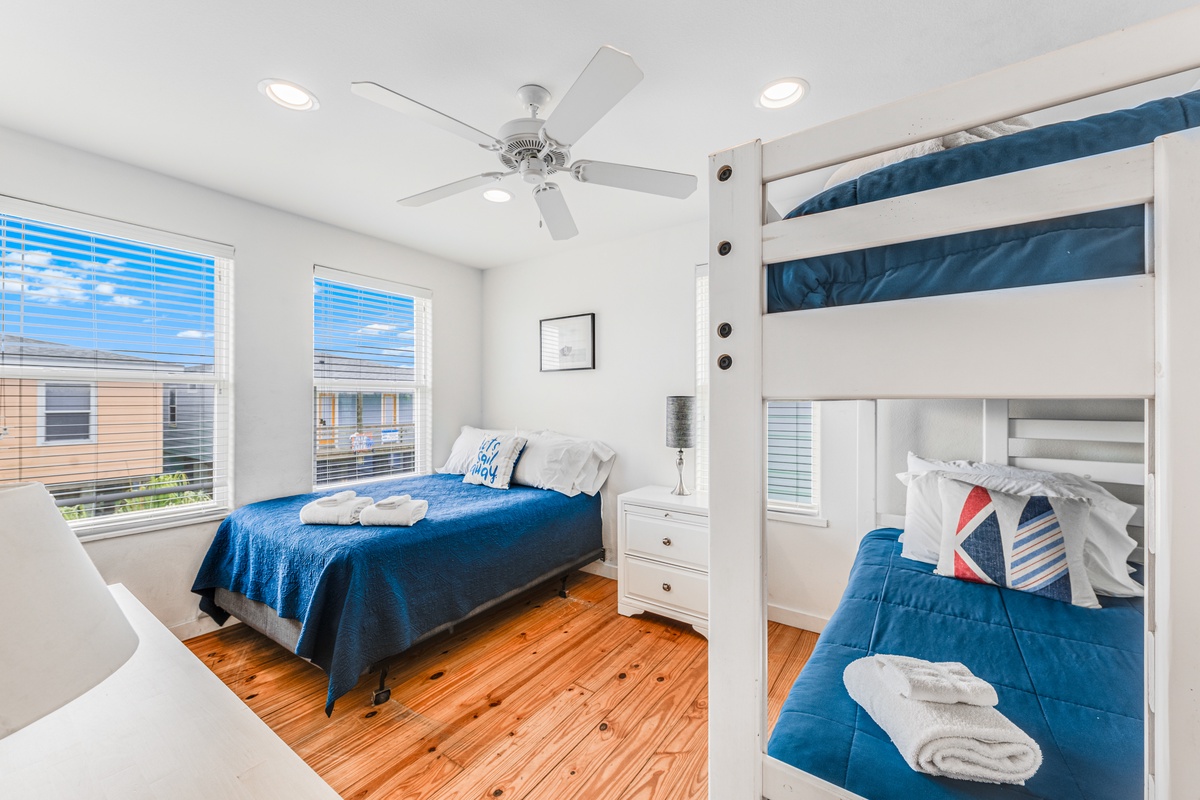 Your comfortable bedroom features fresh linens, ceiling fan, and warm wood floors for a perfect night's rest.