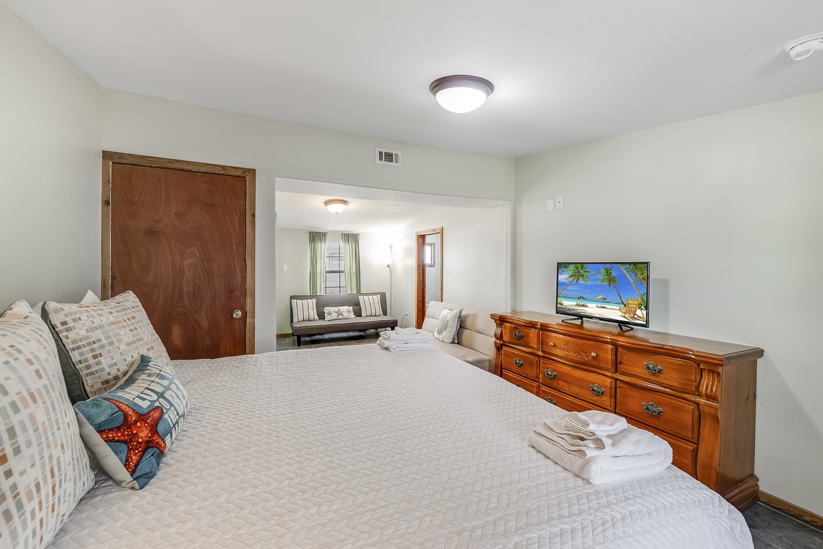 Relax in your comfortable bedroom with plush bedding, TV entertainment, and adjoining seating area for ultimate comfort.