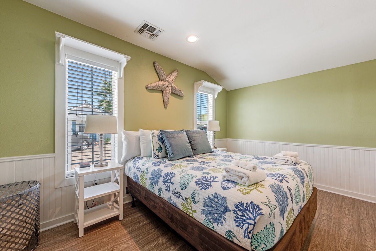 Drift off peacefully in this coastal-inspired bedroom with ocean-themed linens, charming starfish accent, and gentle natural light.