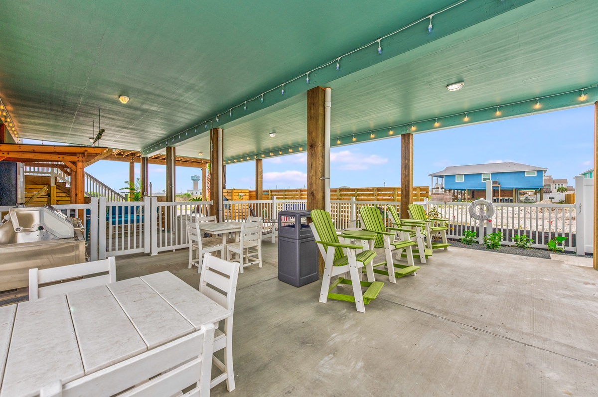 Your private covered patio offers comfortable seating and dining space with twinkling string lights creating the perfect ambiance for relaxing evenings.