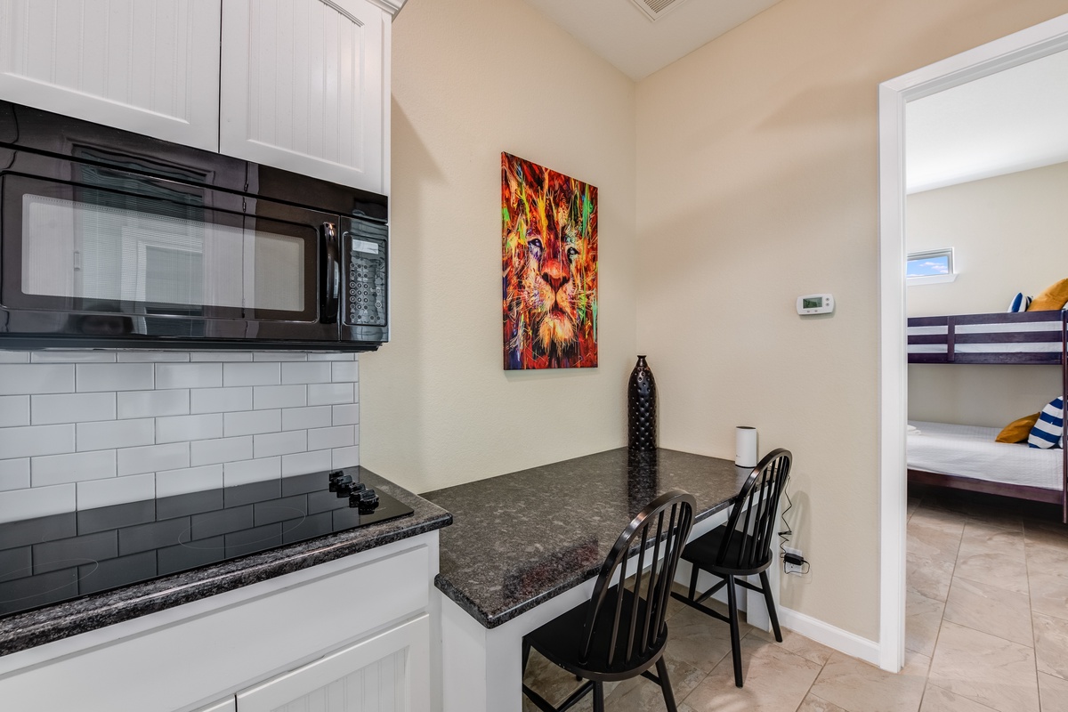 Your compact kitchen features modern appliances and a cozy breakfast bar, perfect for preparing light meals during your stay.
