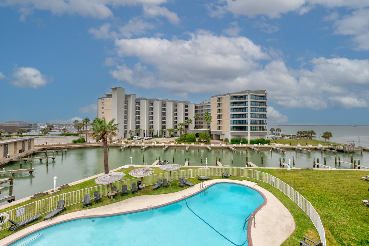 Waterfront property featuring pool, marina access, and scenic bay views in a peaceful coastal setting.