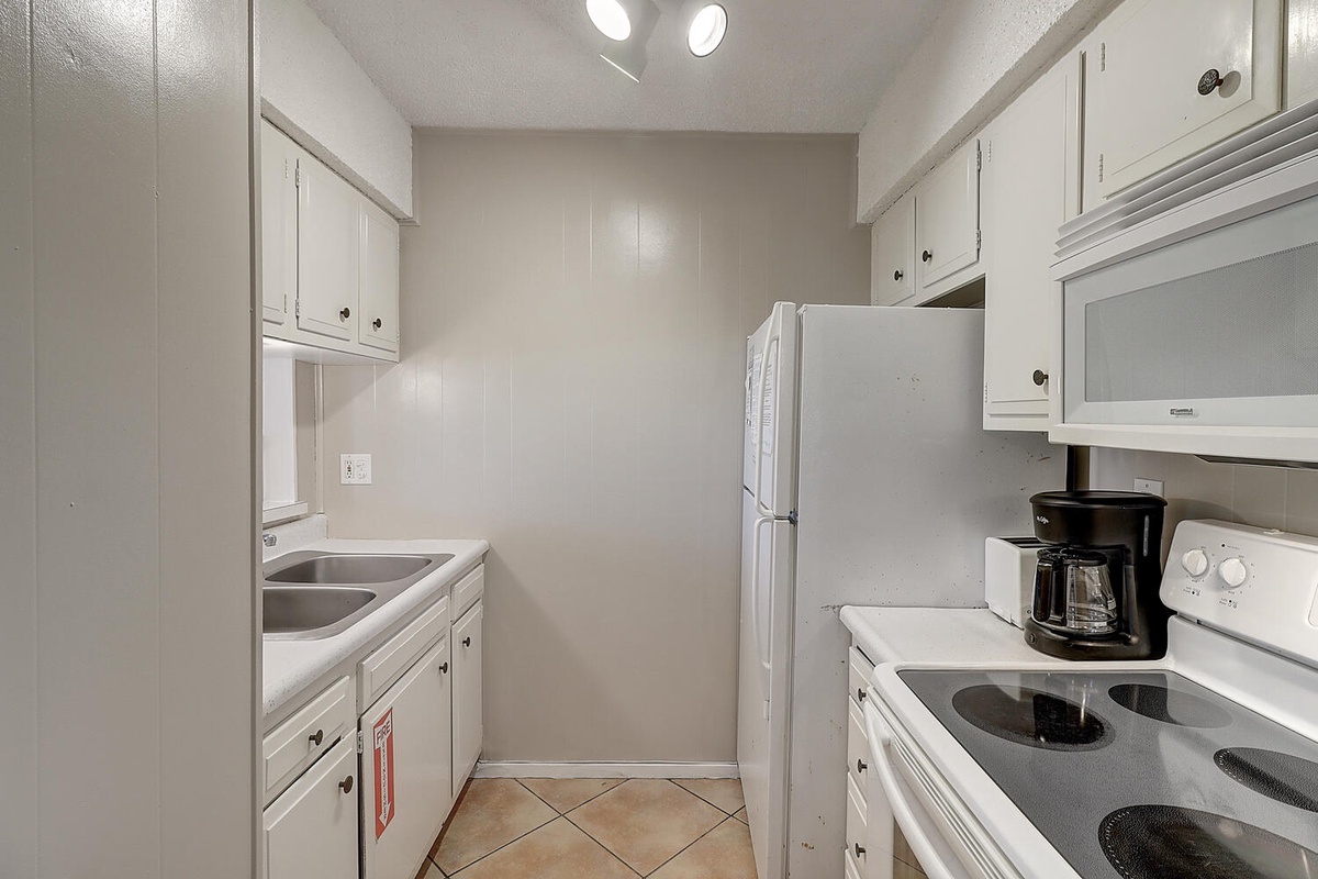 Your fully equipped galley kitchen features everything needed for home-cooked meals, from morning coffee to family dinners.