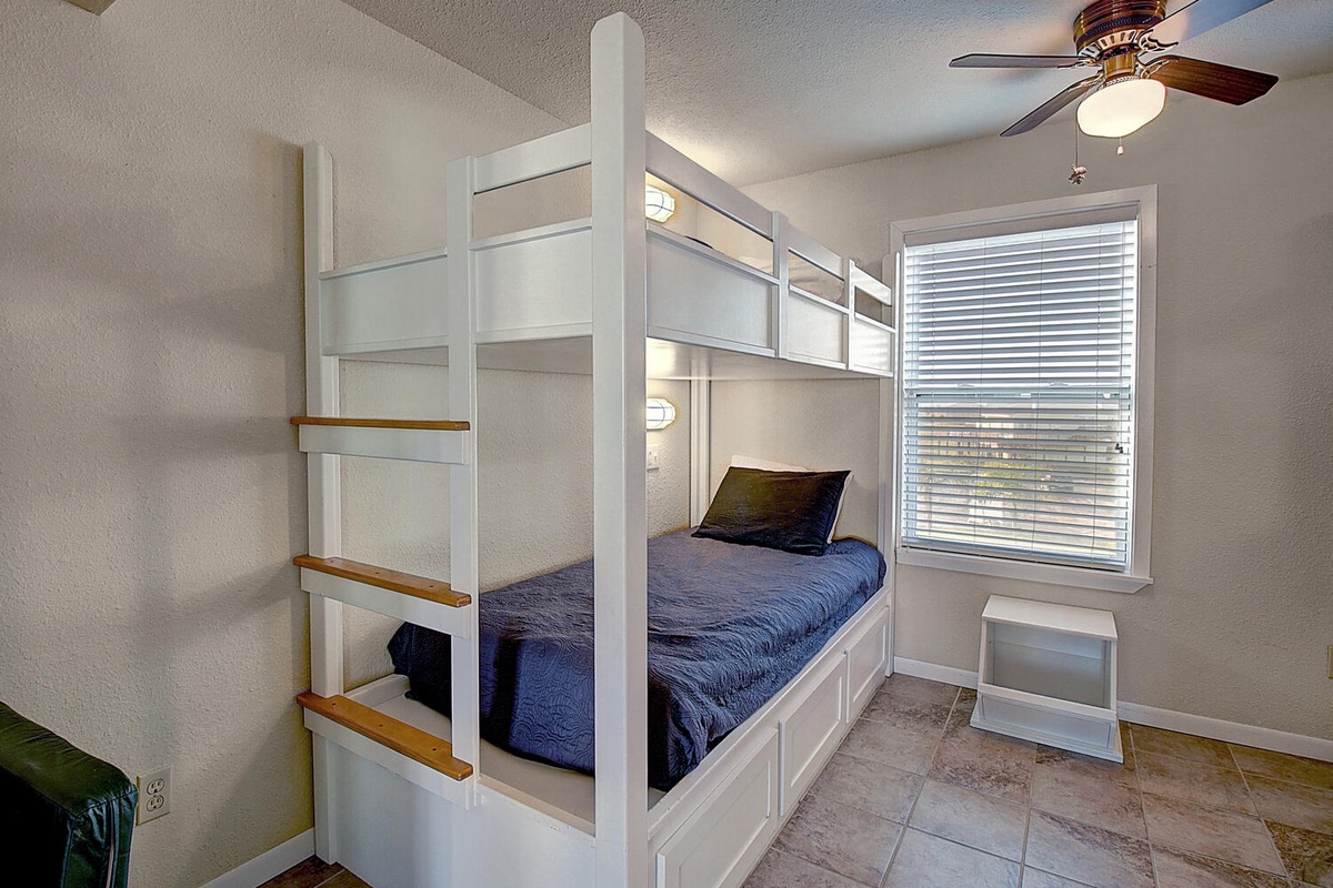 Your cozy bunk room offers comfortable twin beds with reading lights and a ceiling fan for restful nights.