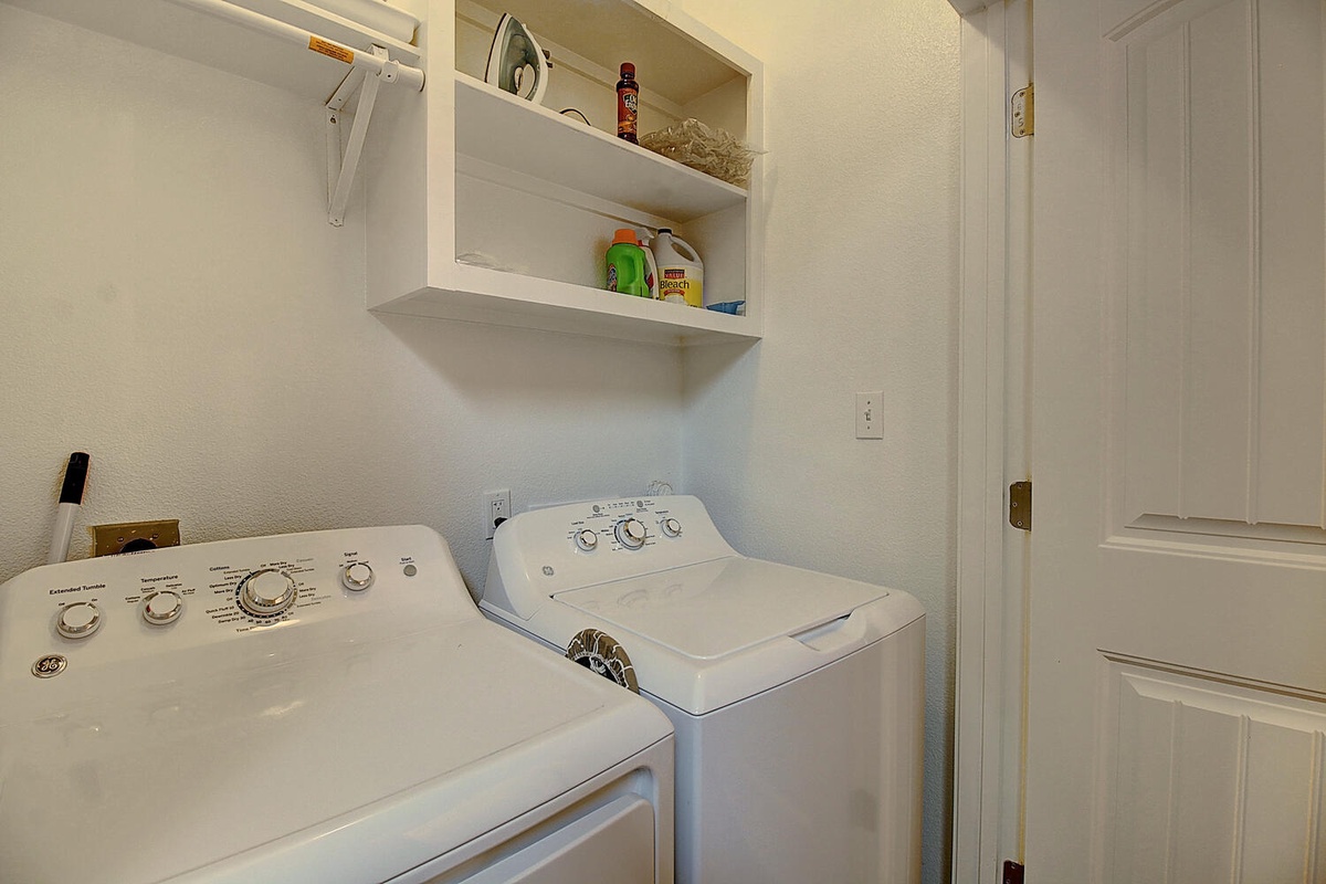 Your dedicated laundry room features full-sized washer and dryer with organized storage above for all your travel essentials.