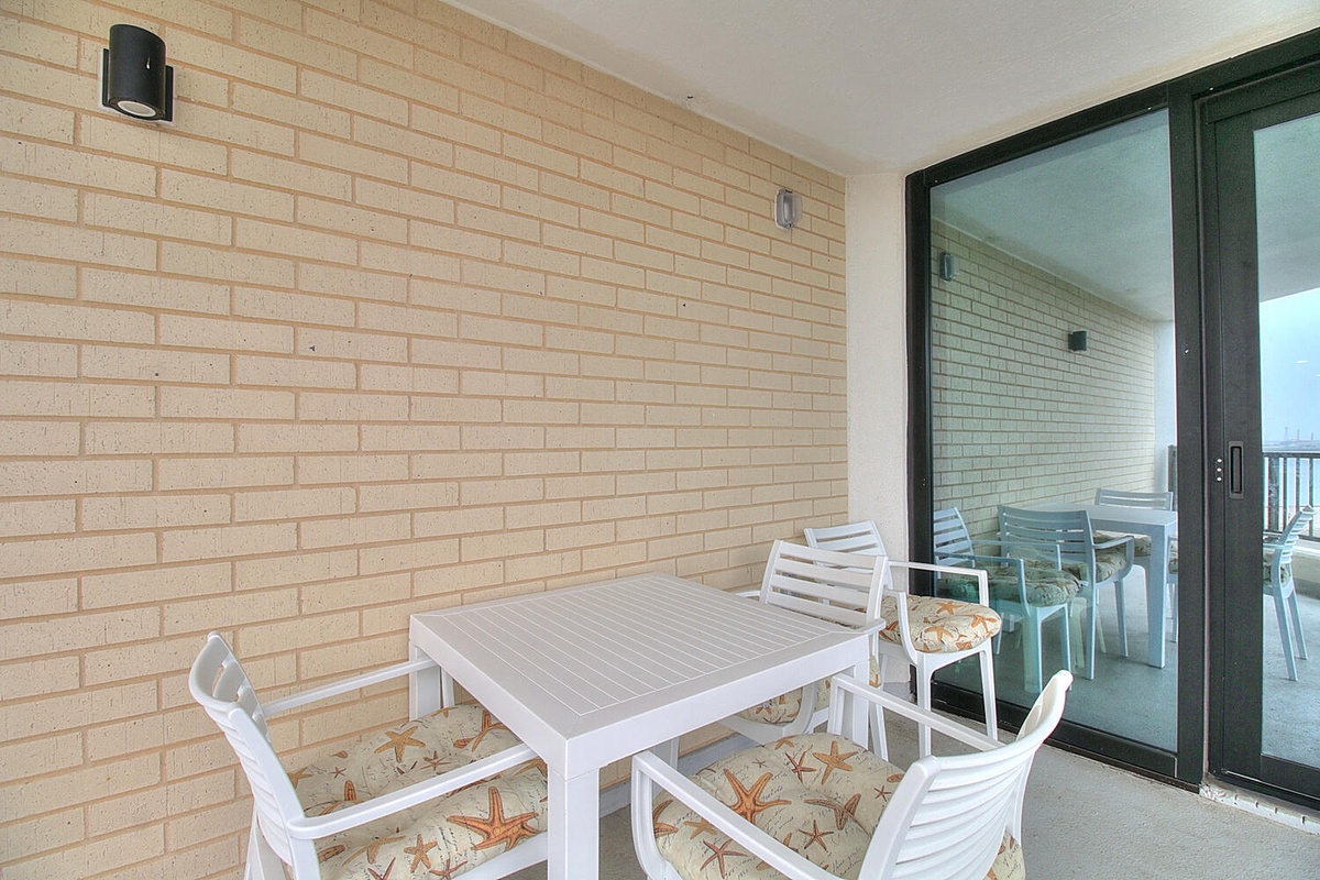 Step onto your private balcony where morning coffee and seaside dining await at your outdoor table.