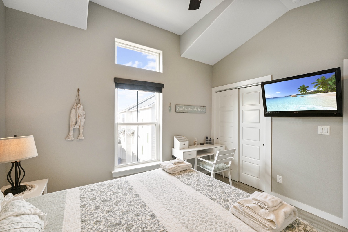 Unwind in your serene bedroom with modern amenities, comfortable furnishings, and entertainment ready for your perfect getaway.