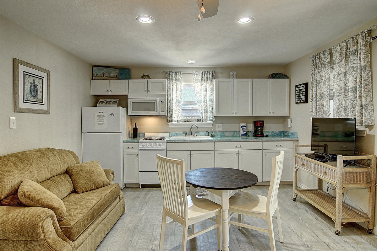 Unwind in your inviting open-plan space where a cozy living area flows into a well-equipped kitchen, perfect for relaxing after exploring.