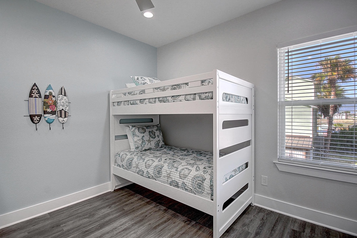 Your kids will love this bright room with crisp white bunk beds and coastal-themed bedding, perfect for sharing vacation memories.