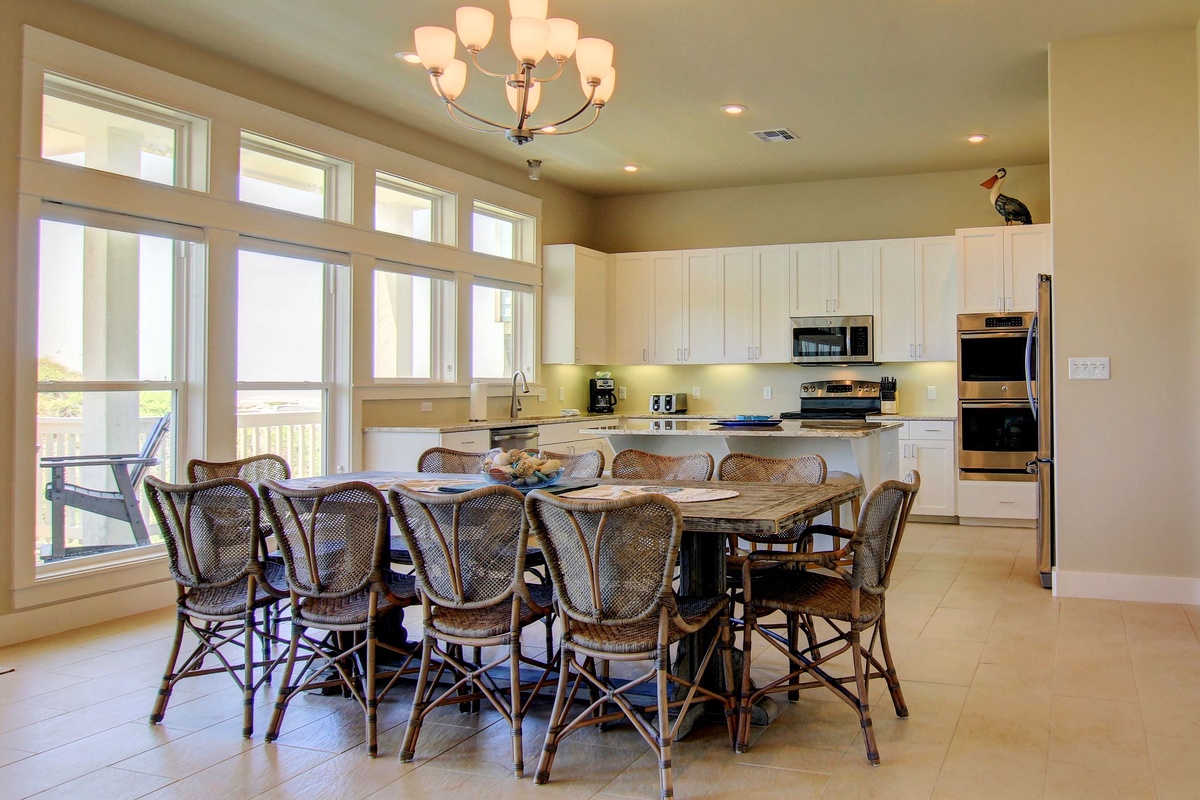 Gather around this spacious dining table where your group can share meals together, with a fully-equipped kitchen ready for cooking adventures.
