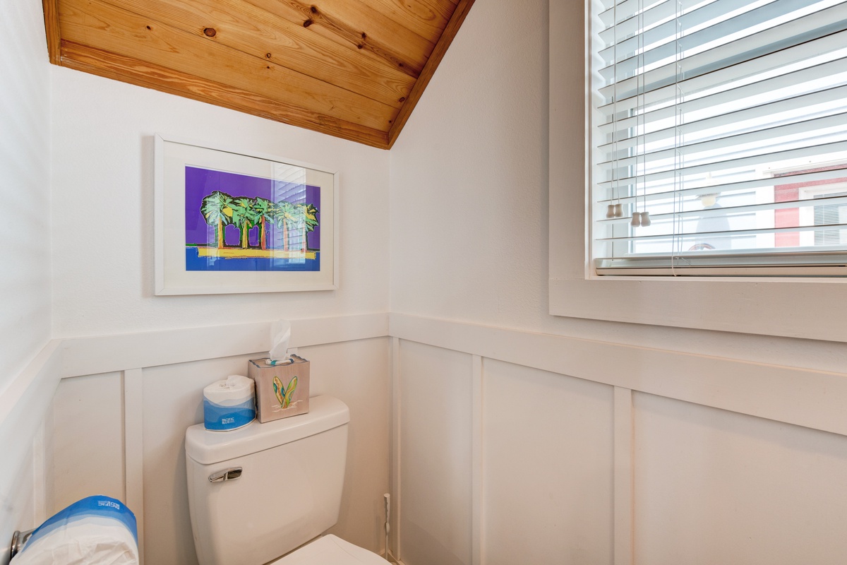 Your private bathroom features warm wood ceiling details and thoughtful touches for your comfort.