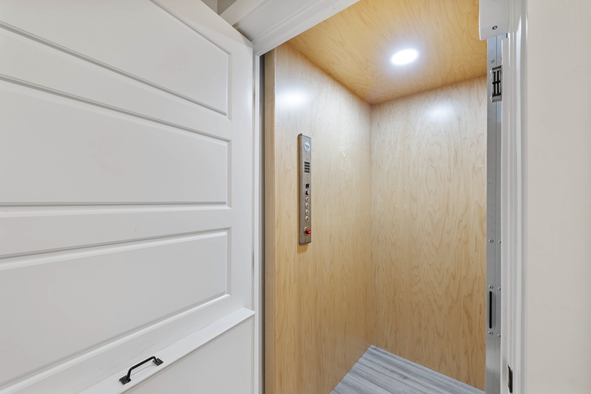 Step into your private elevator with warm wood paneling and modern lighting for effortless access to your floor.