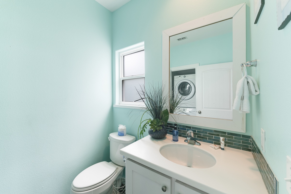 This bright half bath features coastal-inspired finishes and a fresh, welcoming feel.25