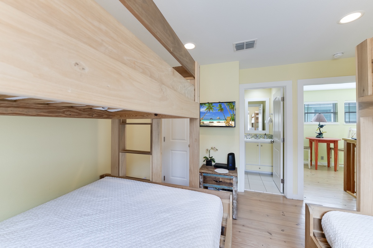 Your cozy bedroom features custom built bunk beds with warm wood finishes, offering comfort and space efficiency for your stay.