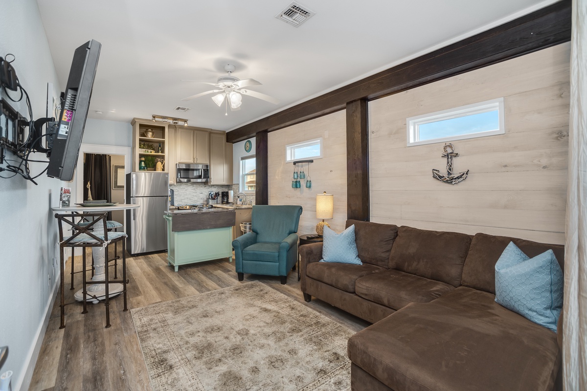 Relax in your cozy coastal retreat with plush seating, modern kitchen, and nautical touches that make you feel right at home.