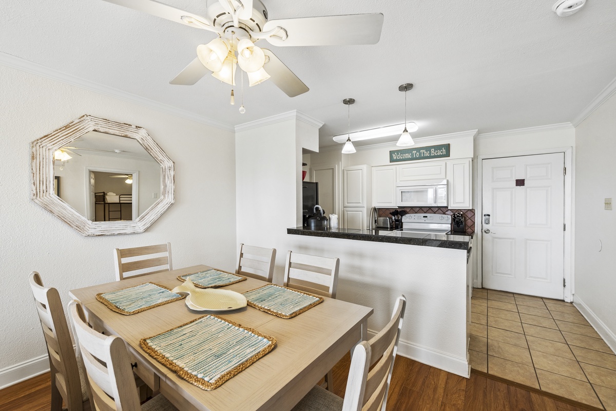 Gather around the table for family meals in your bright, open dining space that flows seamlessly into the fully-equipped kitchen—perfect for creating beachside memories together.