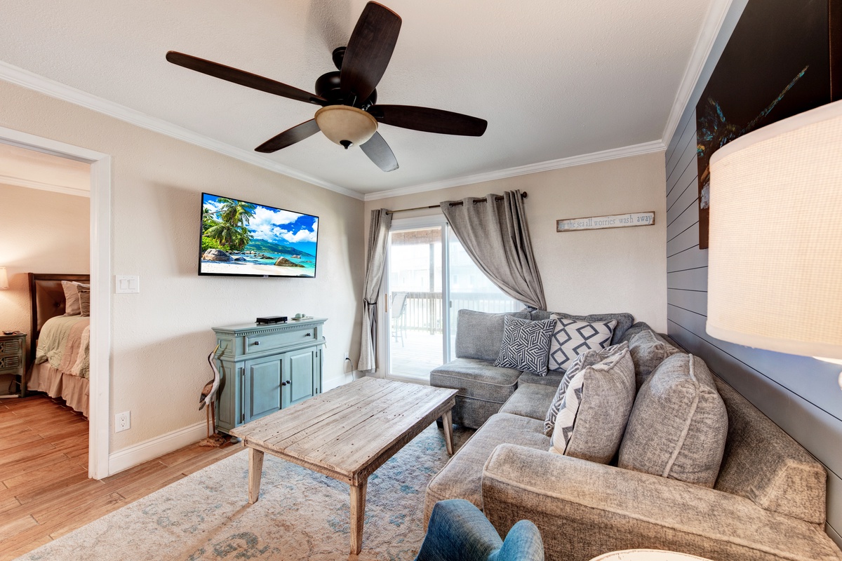 Unwind on your plush sectional while the ceiling fan keeps you cool and natural light streams through your private balcony doors.