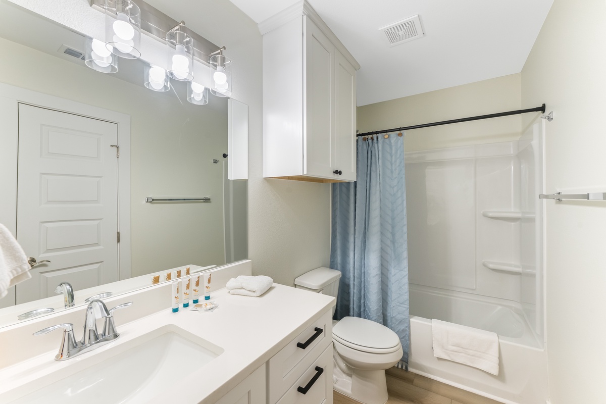 Step into your sparkling clean bathroom with modern vanity, refreshing shower, and thoughtful amenities ready for your comfort.