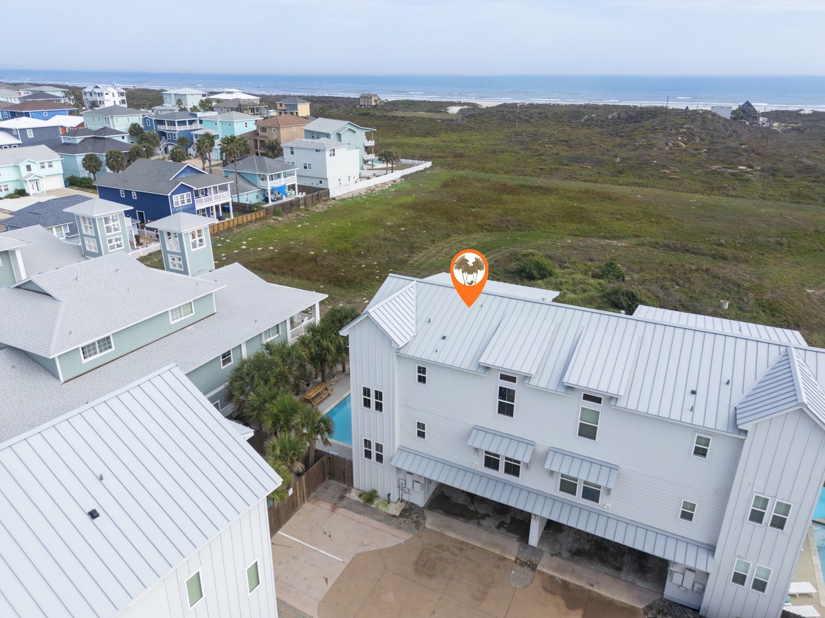Coastal vacation rental community featuring modern beach homes with metal roofs, natural landscapes, and ocean proximity.