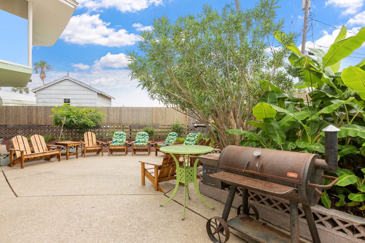 Fire up the BBQ and relax in your private outdoor oasis with comfortable seating and tropical landscaping.
