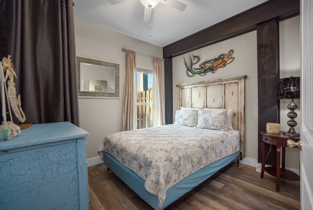 Unwind in your coastal-inspired bedroom where rustic wood beams meet ocean art and soft linens promise restful nights.