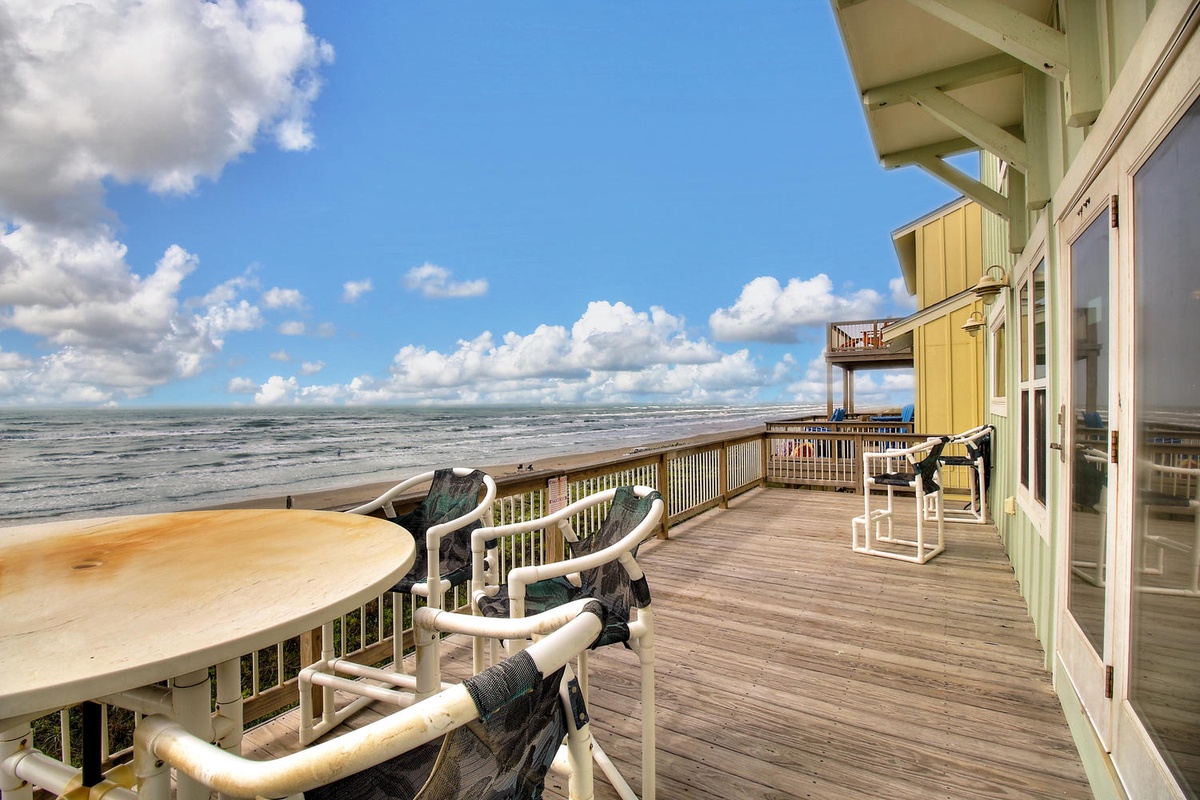 Your oceanfront deck offers stunning views where you can relax with morning coffee while watching waves roll in and beachgoers below.