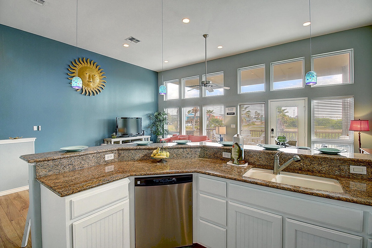 Your open kitchen flows seamlessly into the living area, featuring granite countertops and stainless appliances perfect for preparing meals.