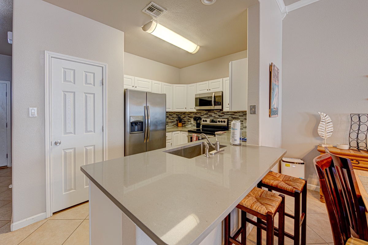 Your spacious kitchen features granite countertops, stainless steel appliances, and a breakfast bar perfect for morning coffee.
