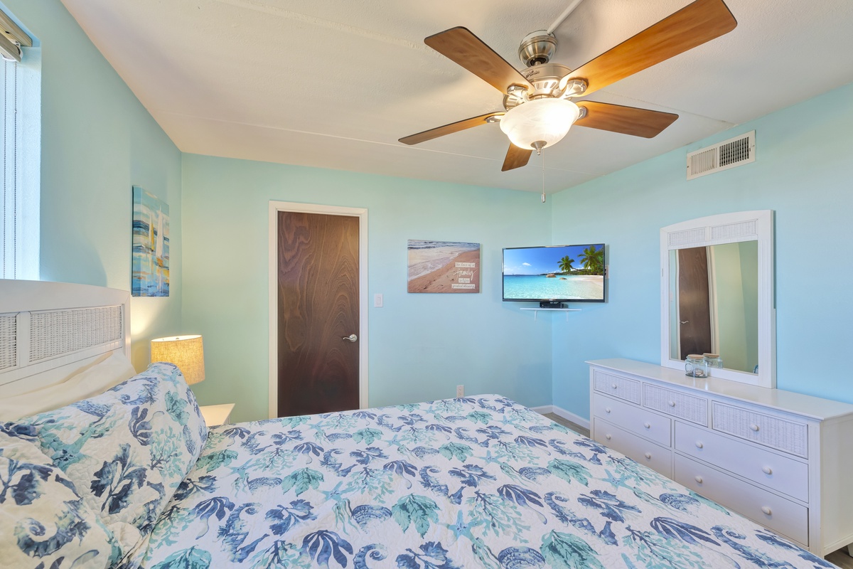 Drift off to peaceful dreams in this soothing coastal bedroom, where tropical linens and sea-glass walls create your perfect beachside retreat.