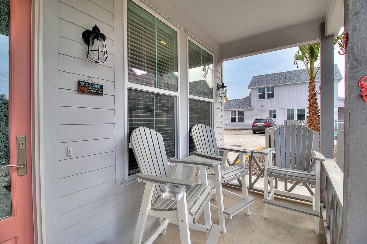 Relax on your private covered porch with comfortable seating, perfect for morning coffee or evening unwinding.