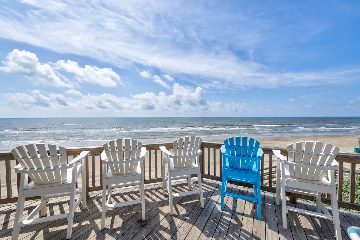 Picture yourself lounging in these Adirondack chairs with the ocean breeze and endless waves as your backdrop. Your perfect beachfront escape awaits.