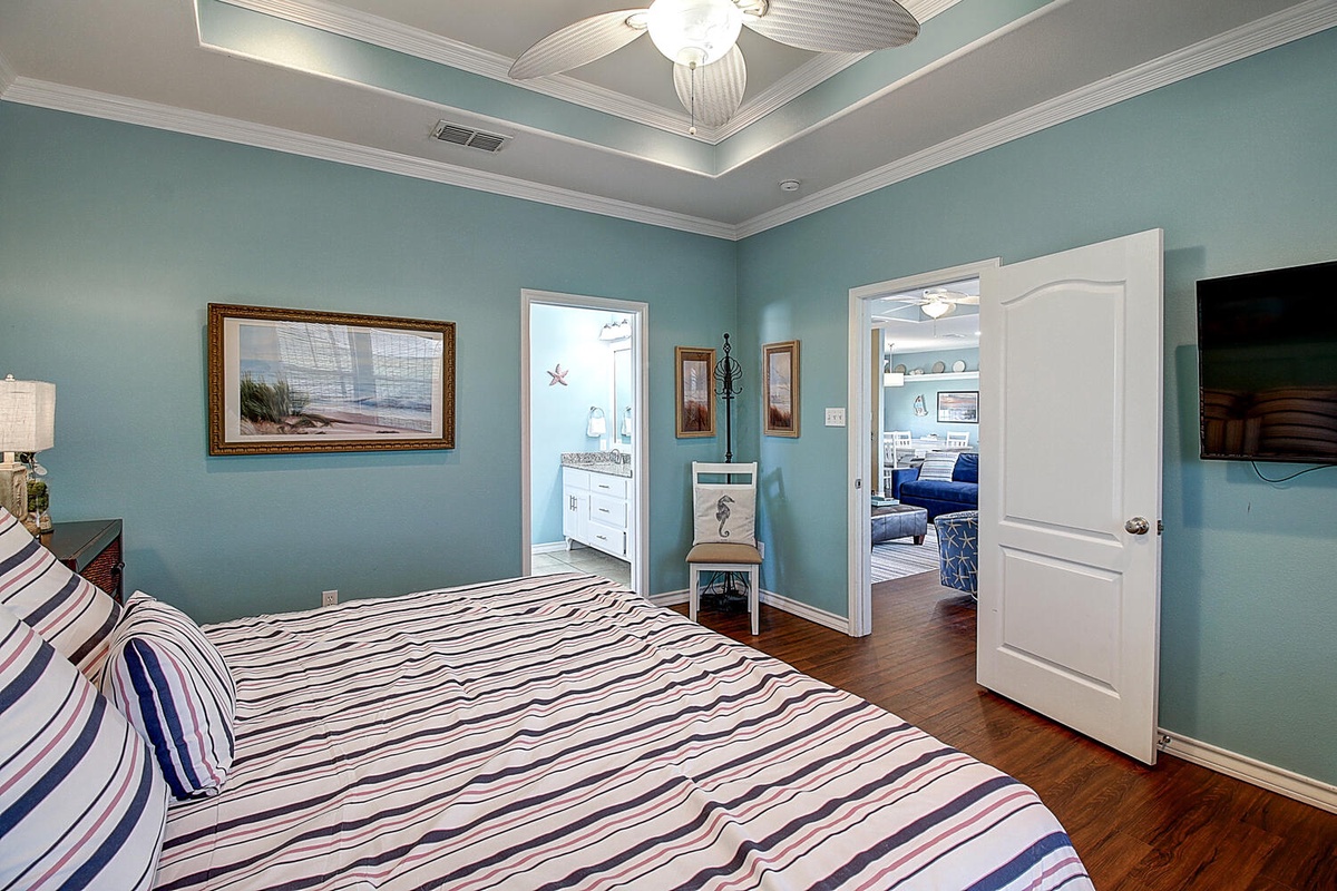 Unwind in your serene bedroom with soothing coastal colors and tray ceiling. Your private bathroom awaits, while living areas beckon beyond.