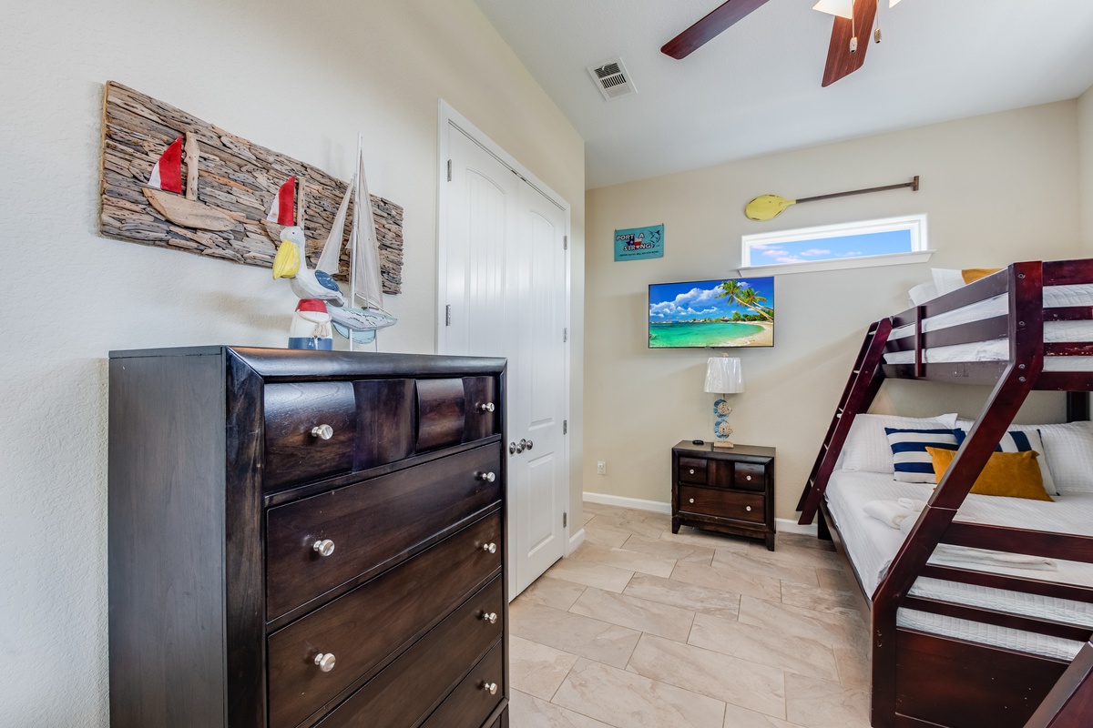 Your kids will love this nautical-themed bunk room with plenty of storage and their own TV for movie nights.